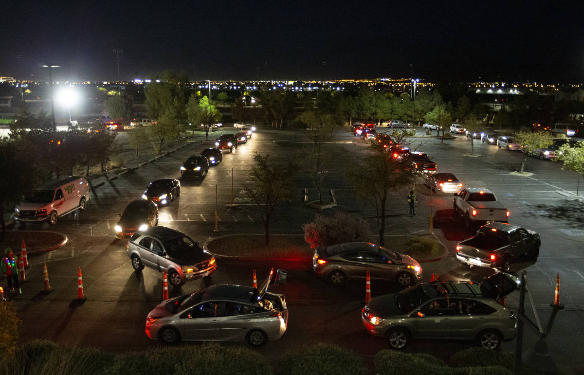 Hundreds of cars line up for Hope for the City's drive-through food pantry and holiday celebrat ...