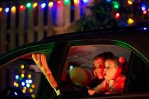Jayleen Valenzuela, 7, left, and Adonai Valenzuela, 2, right, marvel at the holiday decorations ...