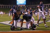 Virginia players take a knee after an NCAA college football game against Abilene Christian, Sat ...