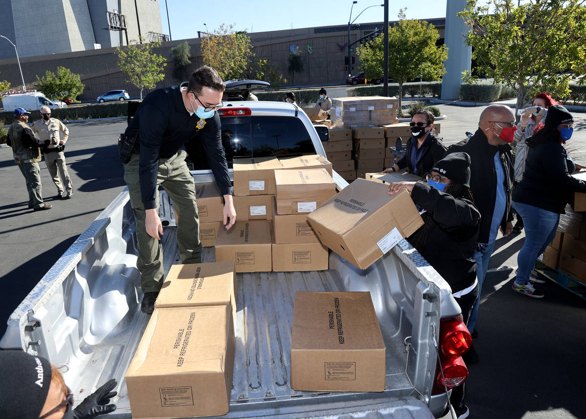 Las Vegas police officer Daniel Russie loads turkeys at Metropolitan Police Department headquar ...