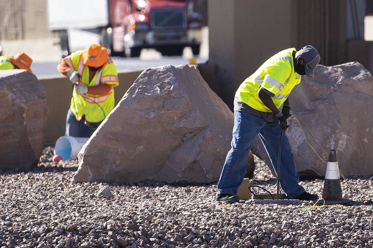 Workers from the Nevada Department of Transportation (NDOT) replace copper wire after Spaghetti ...