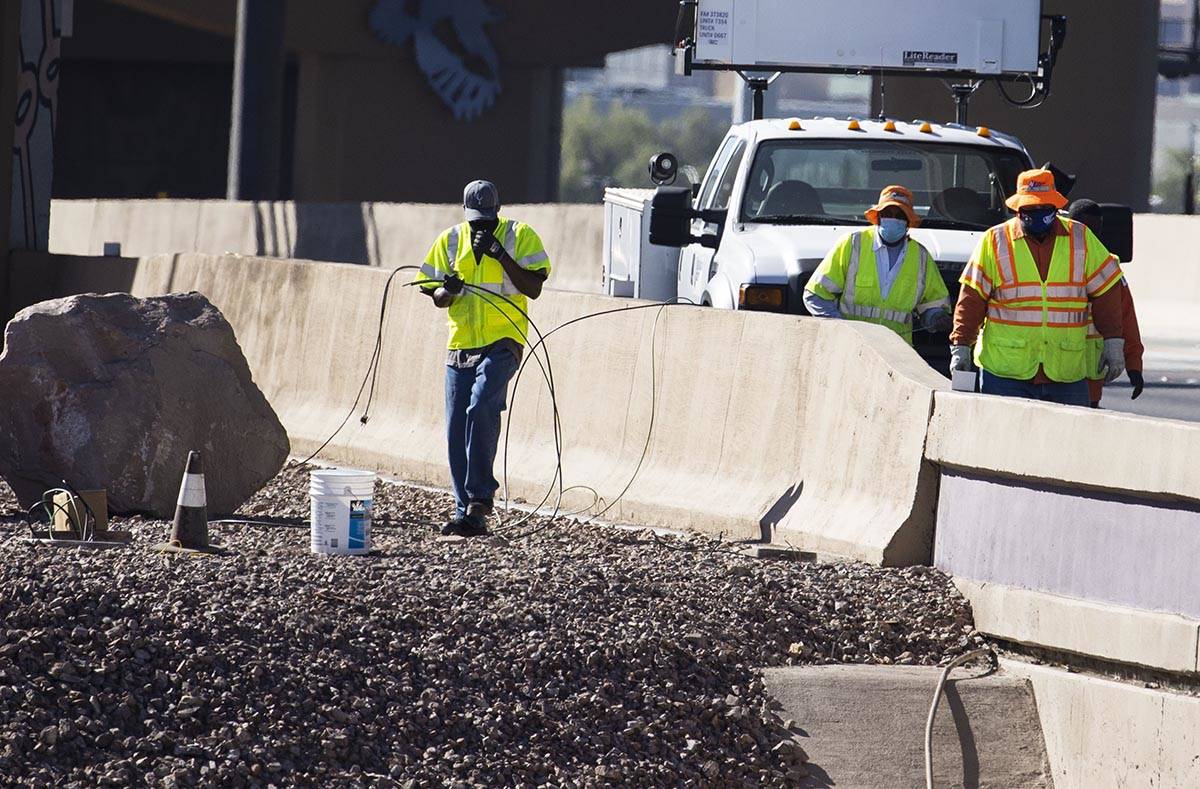 Workers from the Nevada Department of Transportation (NDOT) replace copper wire after Spaghetti ...