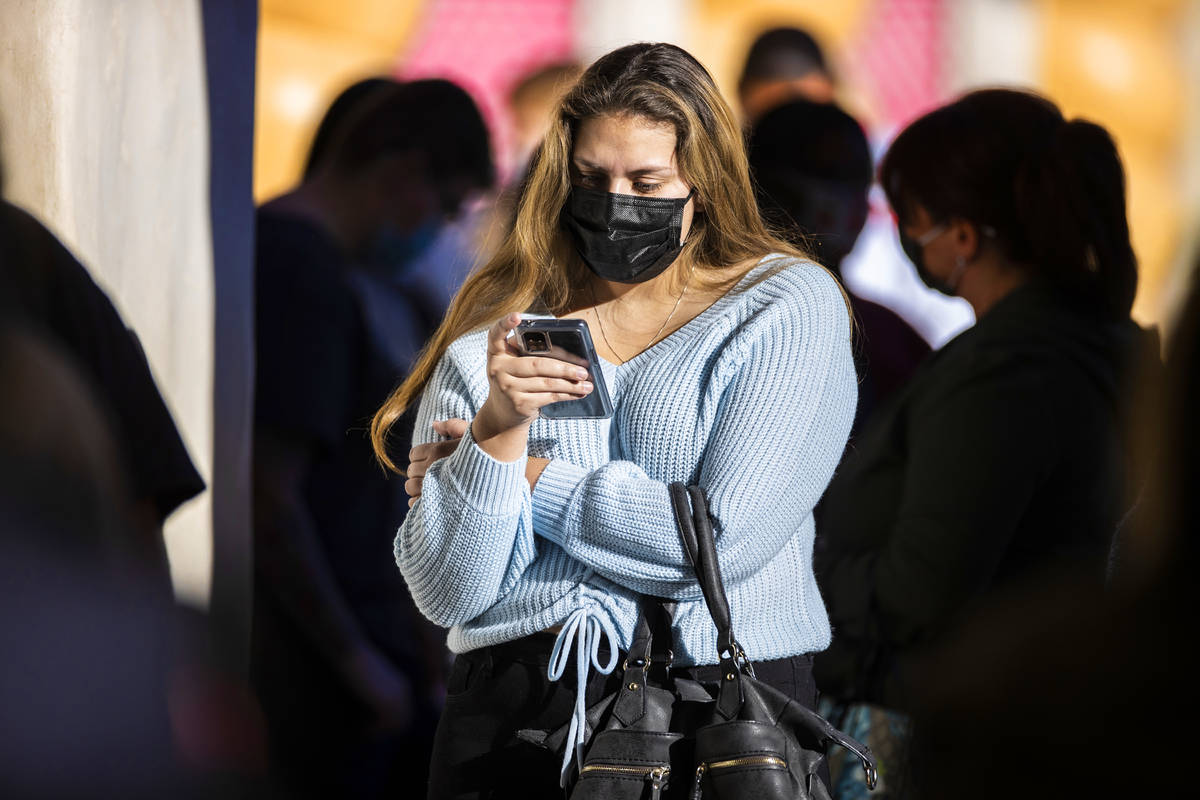 Shoppers wait in line outside Victoria's Secret during Black Friday at Town Square on Friday, N ...