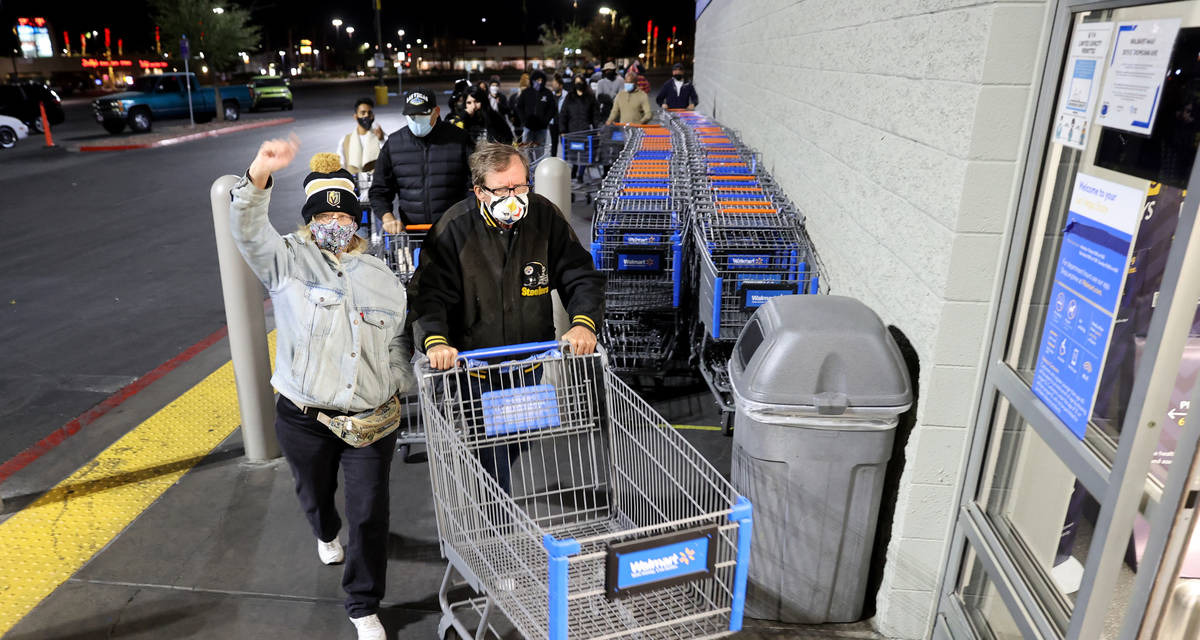 Shoppers, including Judy and Robert Sachetti, both 60 of Las Vegas, file in for the 5 a.m. open ...
