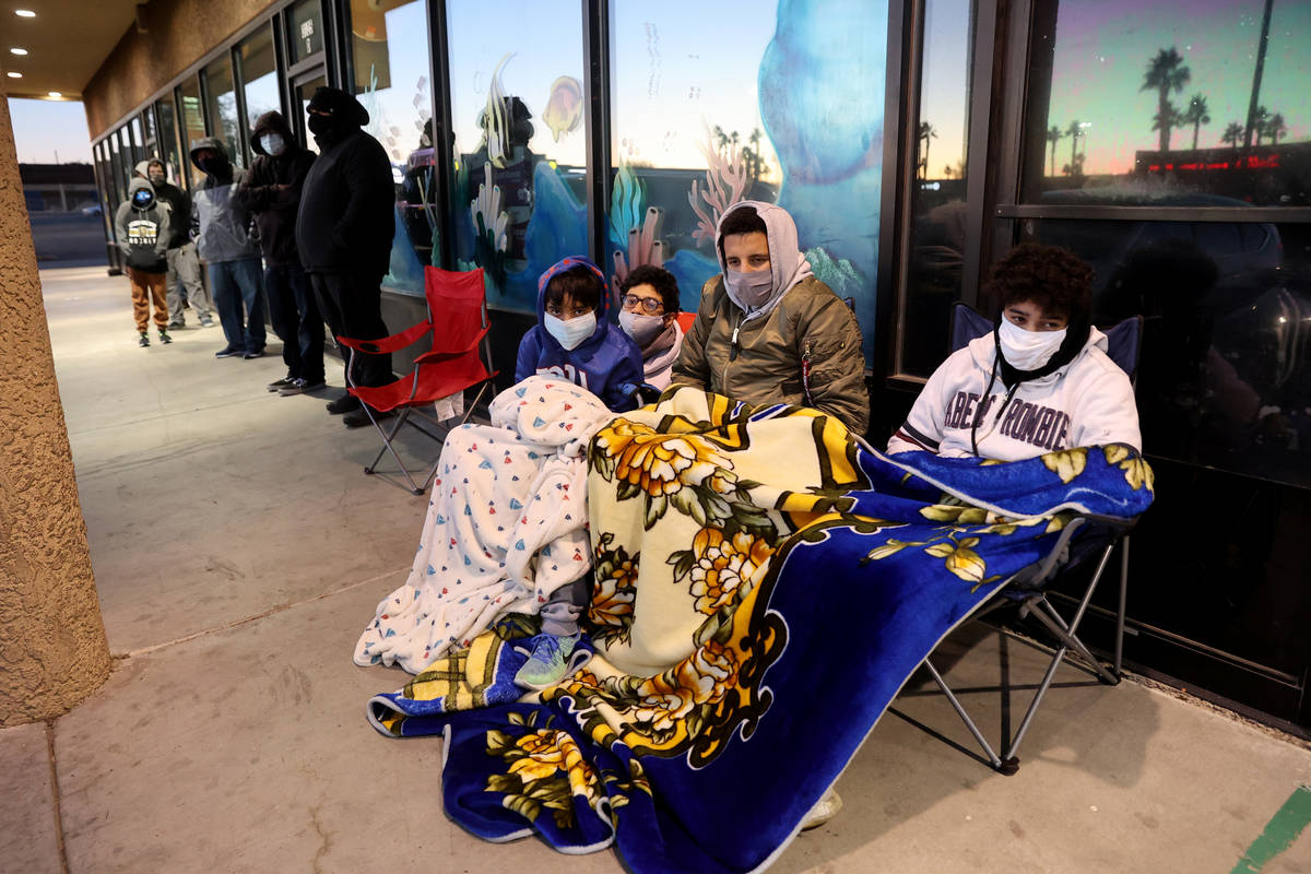 Anwar Ouaddi, 12, from left, Iliass Khould, 16, Mo Khould, 17, and Adam Ouaddi, 16, stay warm w ...