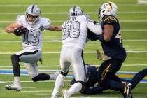 Las Vegas Raiders wide receiver Hunter Renfrow (13) turns the corner around Los Angeles Charger ...