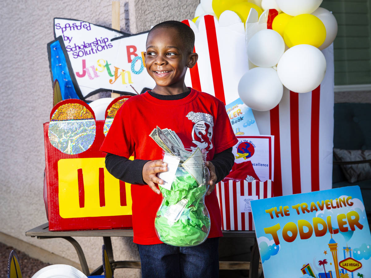 Five-year-old Justyn Boumah, who led a read-a-thon fundraiser, poses for a portrait at his home ...