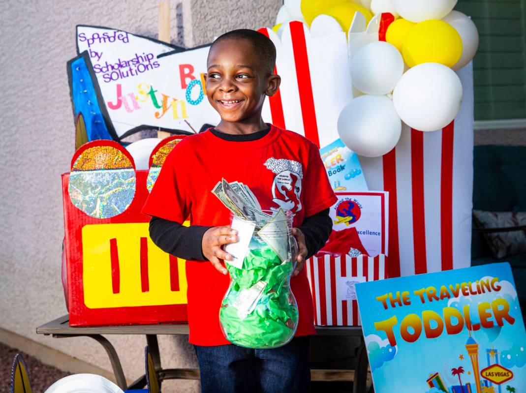 Five-year-old Justyn Boumah, who led a read-a-thon fundraiser, poses for a portrait at his home ...