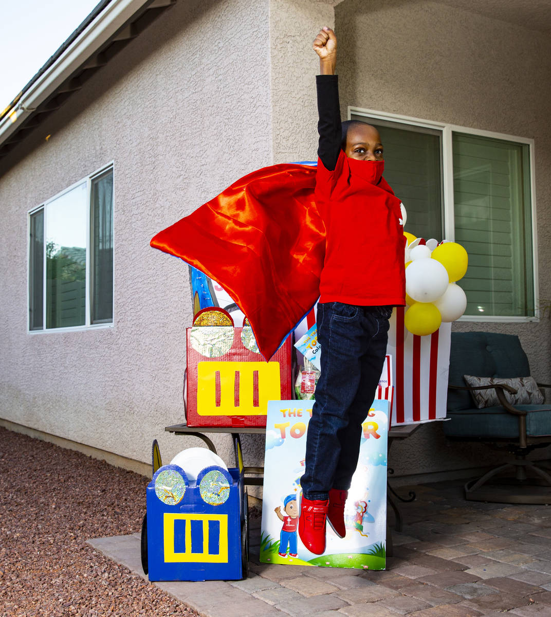 Five-year-old Justyn Boumah, who led a read-a-thon fundraiser, poses for a portrait at his home ...
