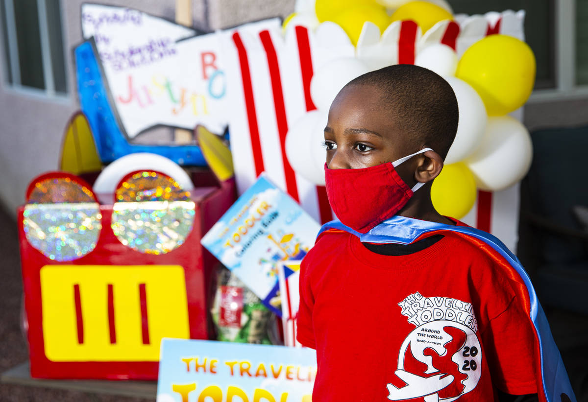 Five-year-old Justyn Boumah, who led a read-a-thon fundraiser, poses for a portrait at his home ...