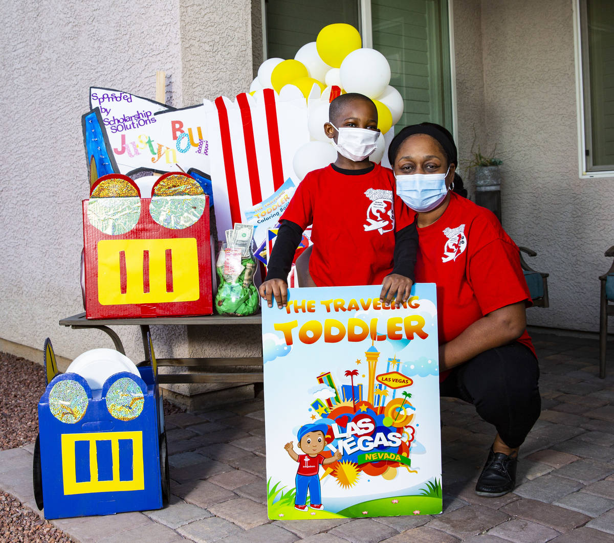Five-year-old Justyn Boumah, who led a read-a-thon fundraiser, poses for a portrait with his mo ...