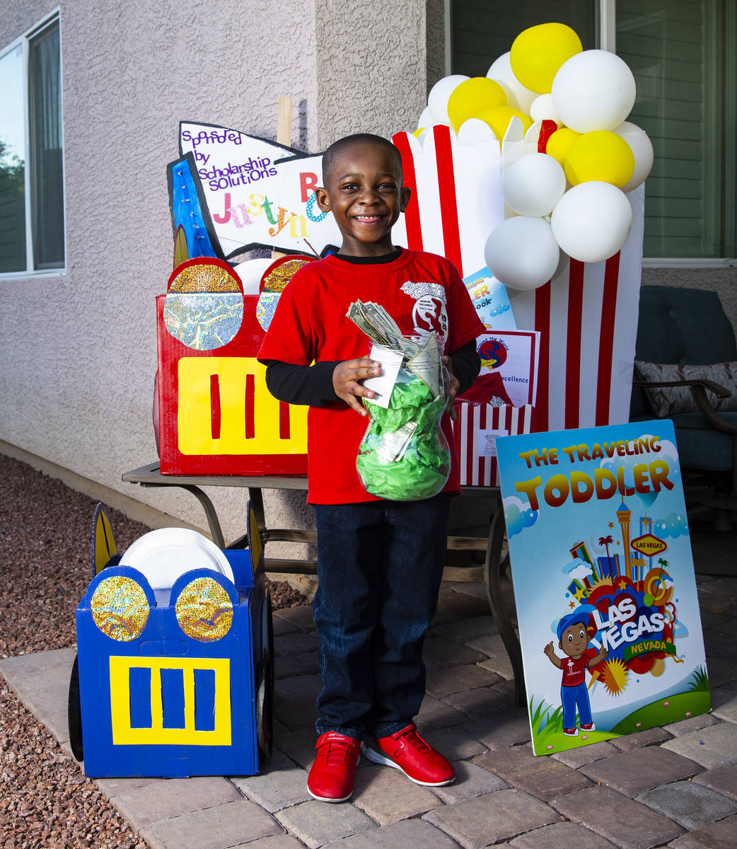 Five-year-old Justyn Boumah, who led a read-a-thon fundraiser, poses for a portrait at his home ...