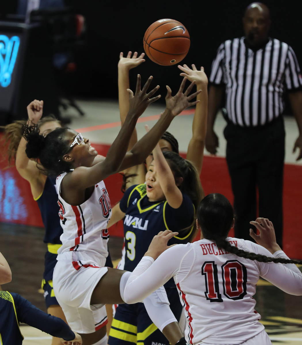 UNLV Lady Rebels forward Desi-Rae Young (23, left) reaches for the rebound over the top of Nort ...