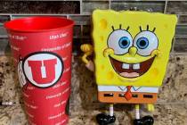 In this photo provided by Utah sports writer Andy Larsen are a childhood piggybank, right, and ...