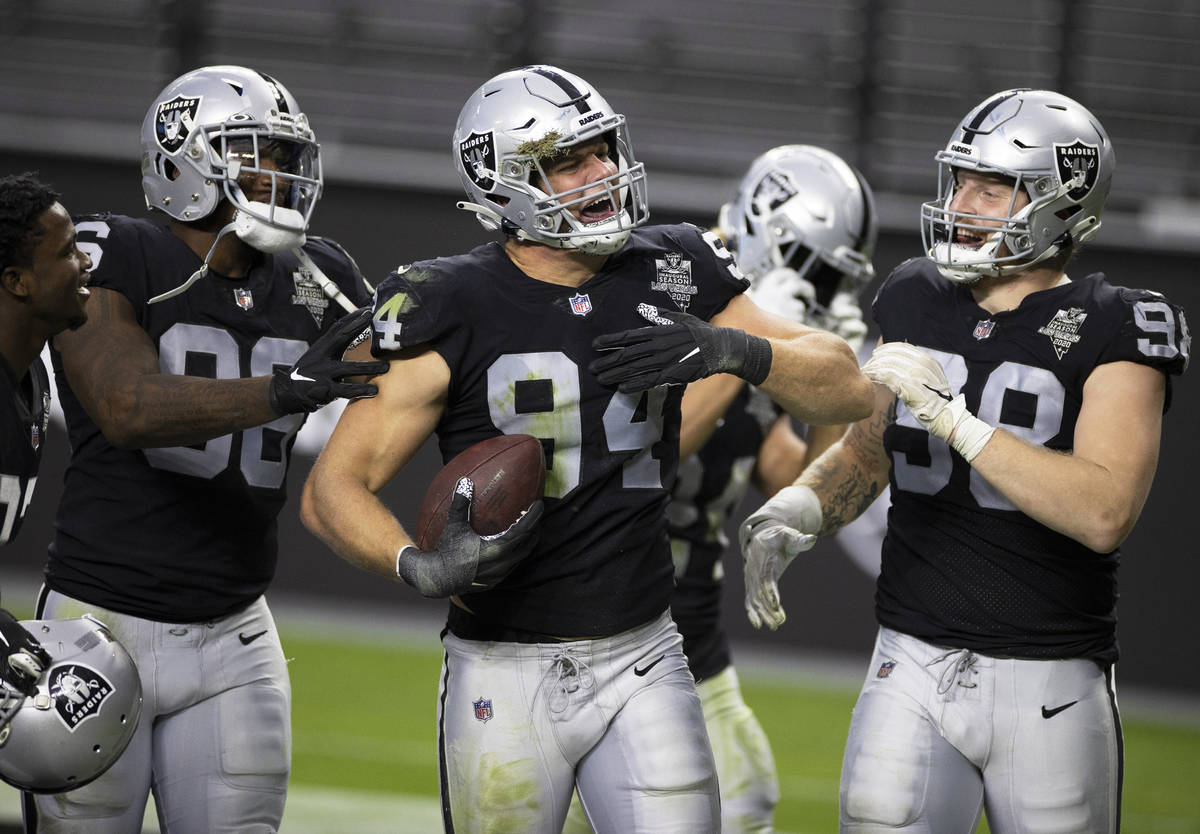 Las Vegas Raiders defensive end Carl Nassib (94) celebrates after intercepting a pass with team ...