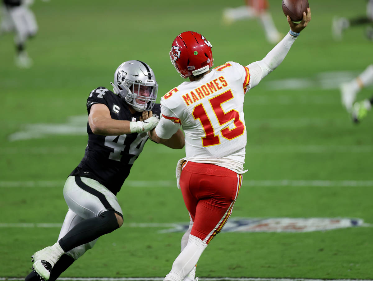 Kansas City Chiefs quarterback Patrick Mahomes (15) throws under pressure from Las Vegas Raider ...