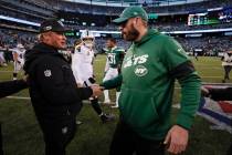 Oakland Raiders head coach Jon Gruden, left, shakes hands with New York Jets head coach Adam Ga ...