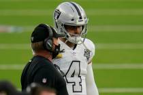 Las Vegas Raiders quarterback Derek Carr, right, talks with head coach Jon Gruden during the se ...