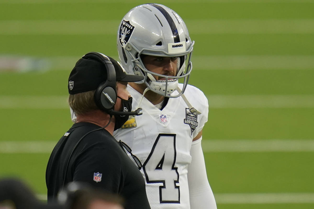 Las Vegas Raiders quarterback Derek Carr, right, talks with head coach Jon Gruden during the se ...