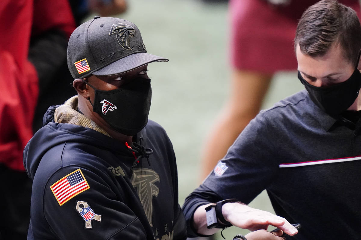 Atlanta Falcons head coach Raheem Morris walks the sidelimne during the first half of an NFL fo ...