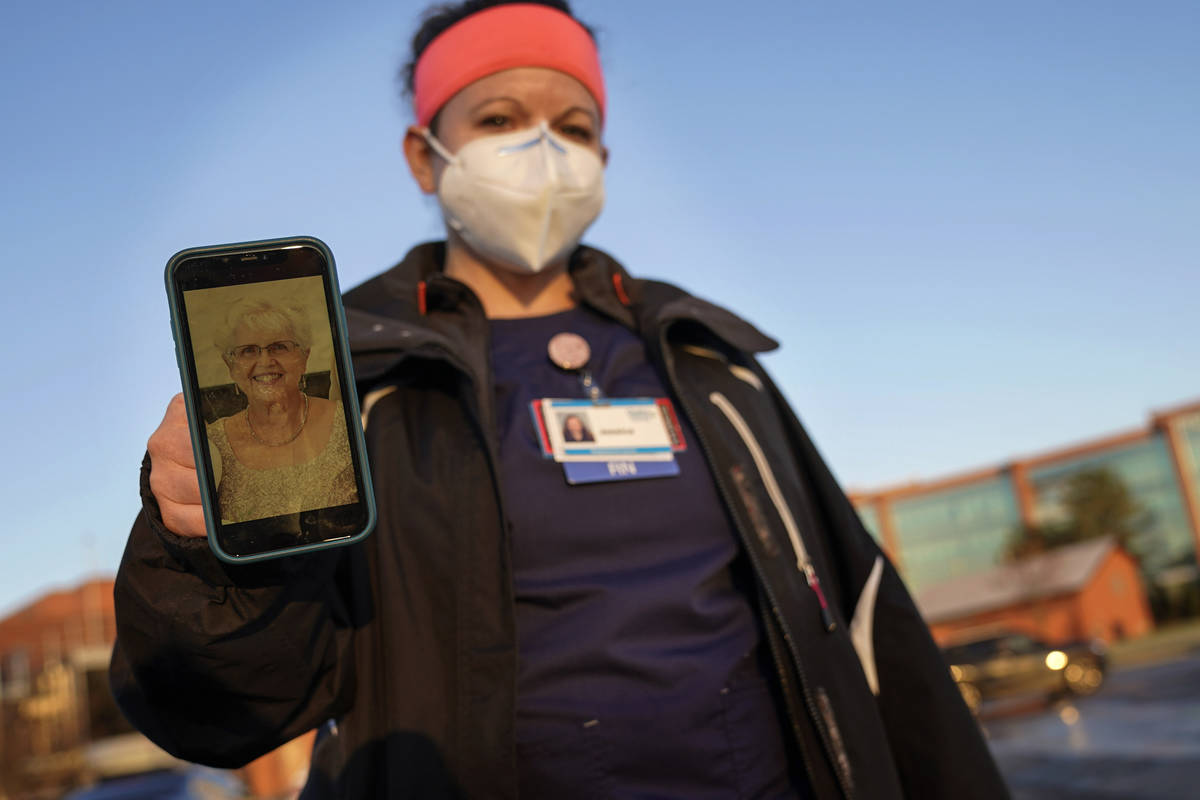 Nurse Jessica Franz, shows a photo of her mother-in-law, Elaine Franz, outside Olathe Medical C ...