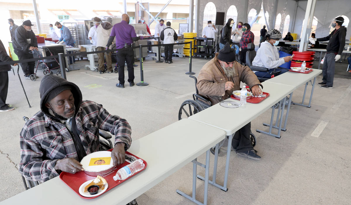 Rickey Milton, from left, Robert Johnson and Atrina Phillips settle in for a socially distanced ...