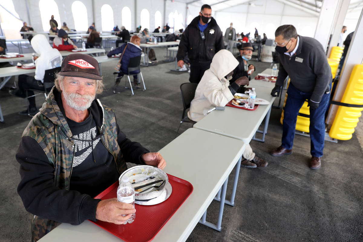 Clients, including Patrick Bailey, 59, left, eat a socially distanced Thanksgiving meal at the ...