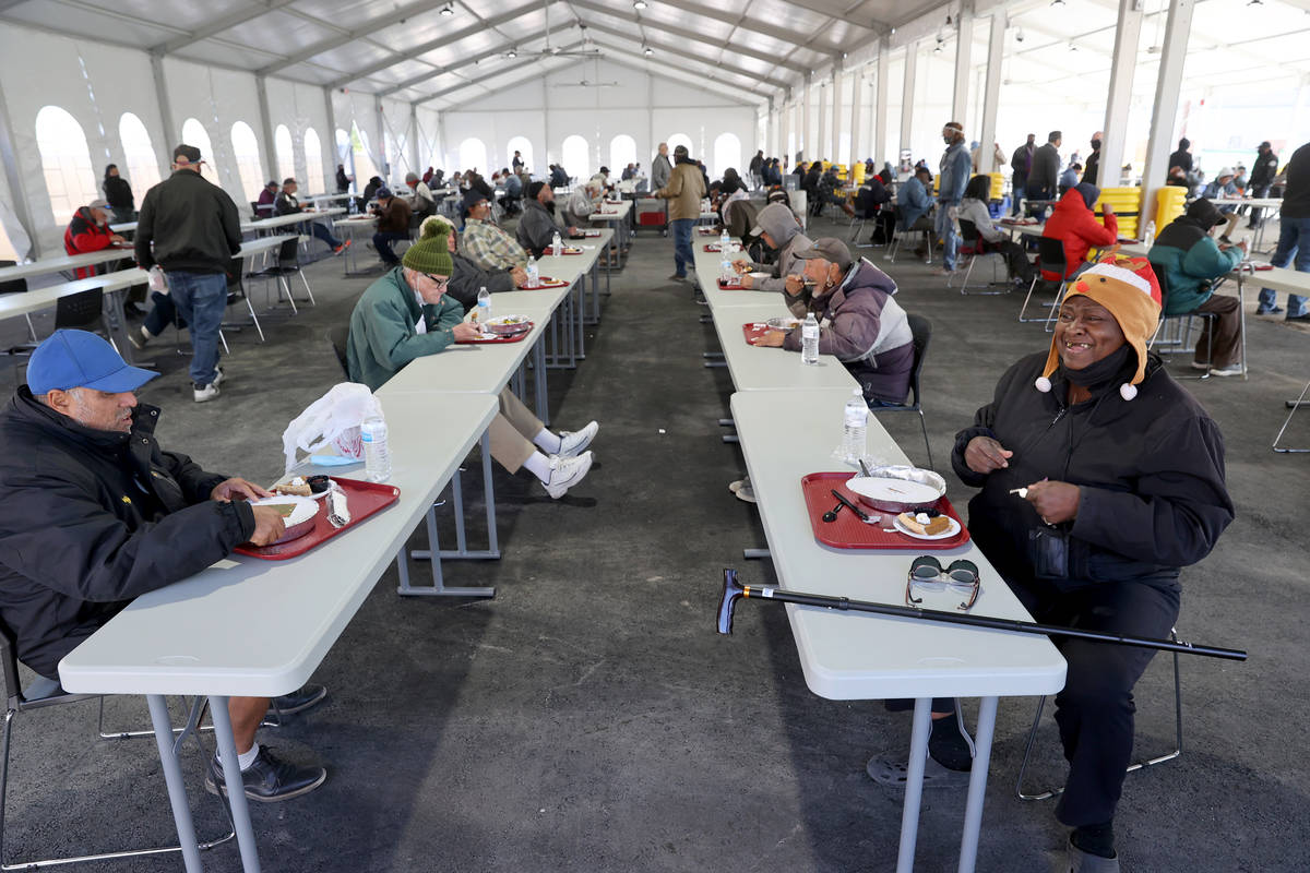 Jacquelyn Gabriel, 64, right, shares a laugh with Michael Poulin, 56, while eating a socially d ...