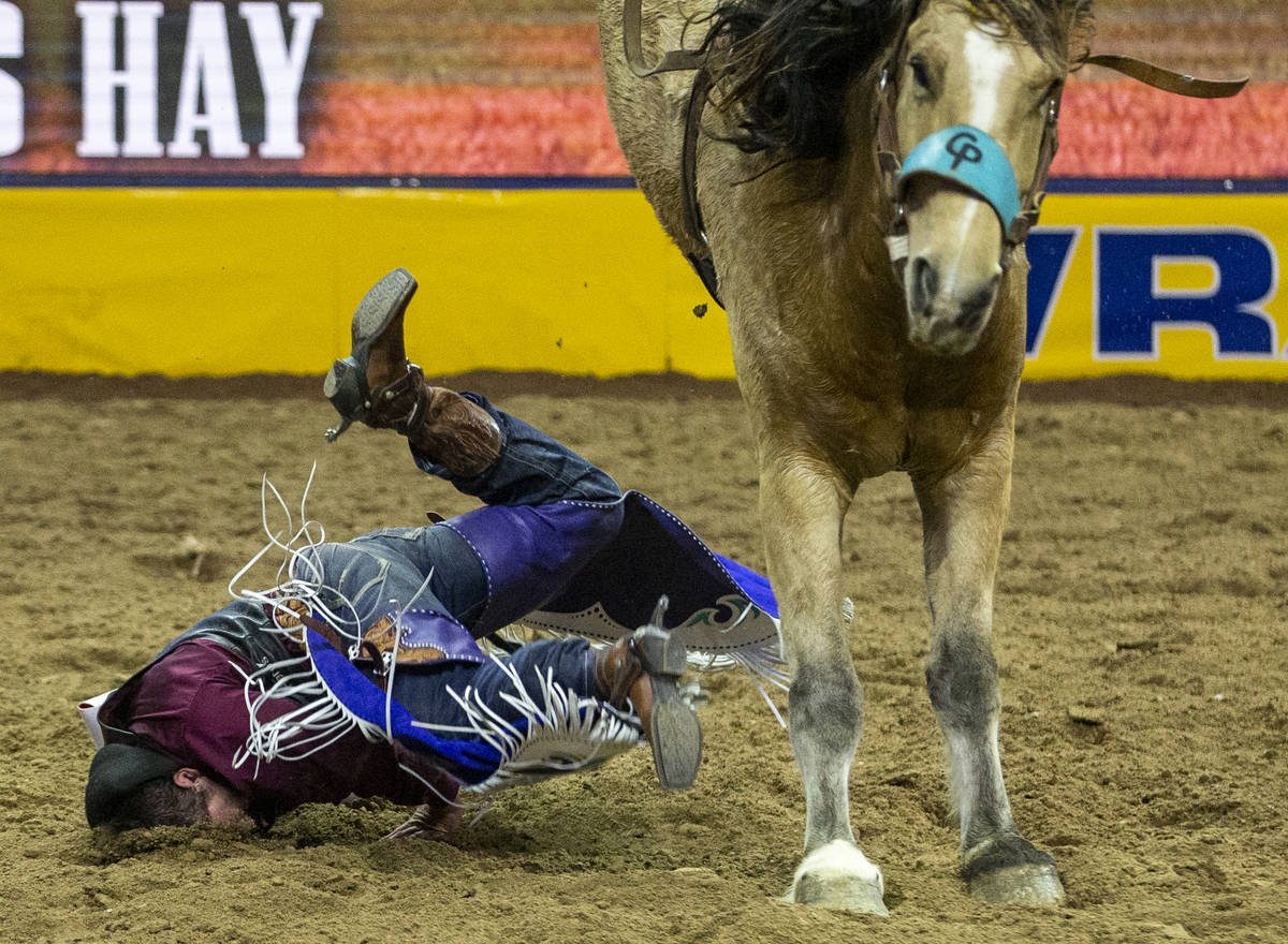 Caleb Bennett of Corvallis, Mont., eats some dirt after a ride in Bareback Riding at the tenth ...