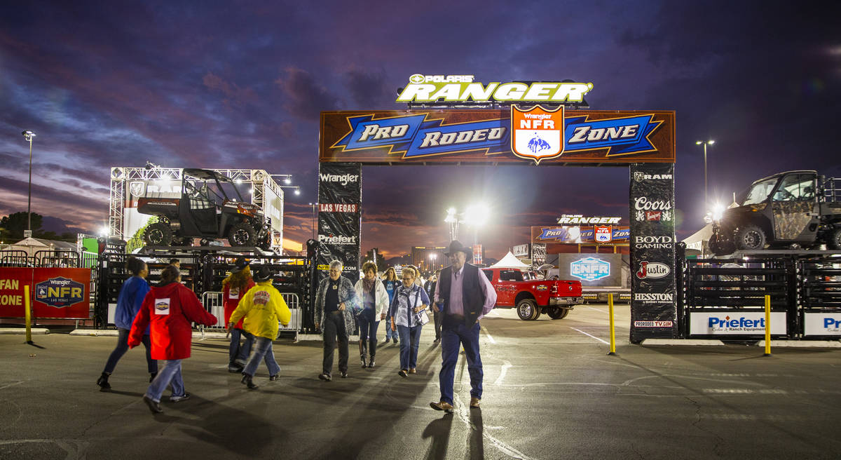 Attendees walk about the Pro Rodeo Zone during the tenth go round of the Wrangler National Fina ...