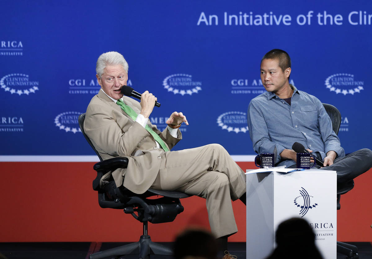 In this June 25, 2014, file photo, former President Bill Clinton, left, speaks with Zappos CEO ...