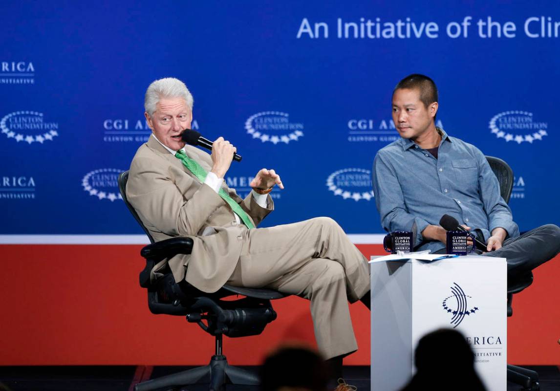 In this June 25, 2014, file photo, former President Bill Clinton, left, speaks with Zappos CEO ...