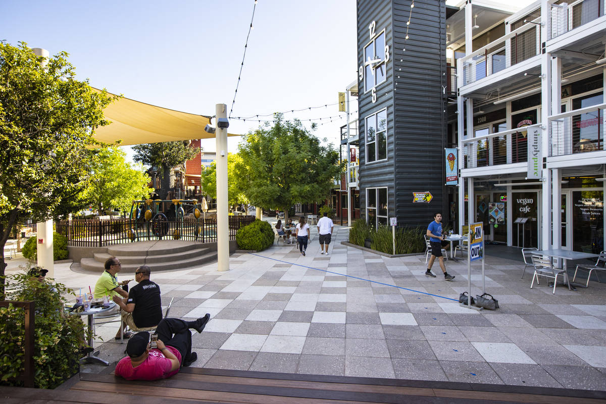 People walk around the Downtown Container Park on the first day of its reopening in downtown La ...