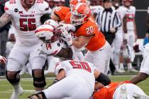 Texas Tech running back Xavier White (14) is tackled by Oklahoma State linebacker Malcolm Rodri ...