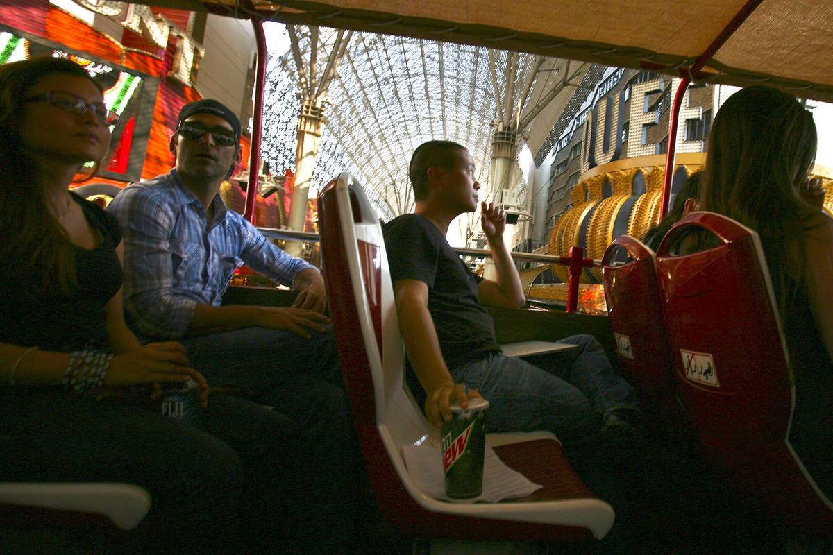 Tony Hsieh, center,CEO of of online clothing maker Zappos.com, during Big Bus downtown tour, T ...