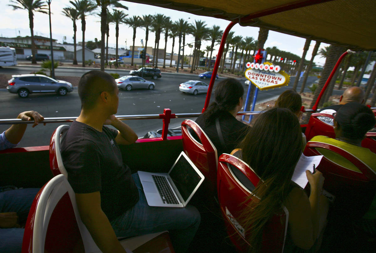 Tony Hsieh, CEO of of online clothing maker Zappos.com, passes the "Welcome to downtown L ...