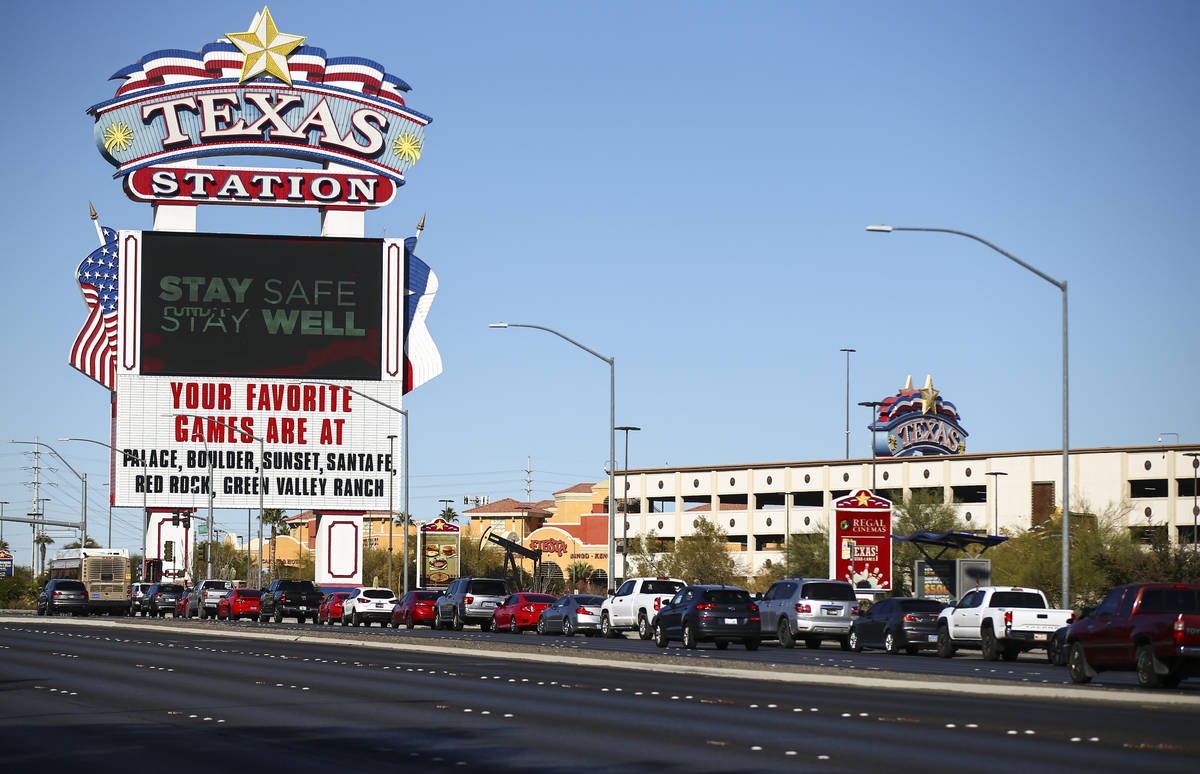 People wait in line at the drive-thru COVID-19 testing site at Texas Station in North Las Vegas ...