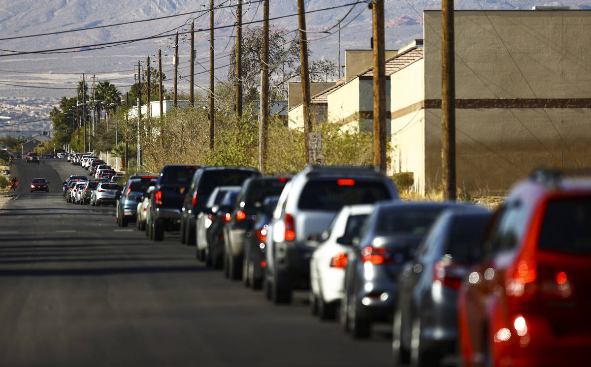People wait in line at the drive-thru COVID-19 testing site at Texas Station in North Las Vegas ...