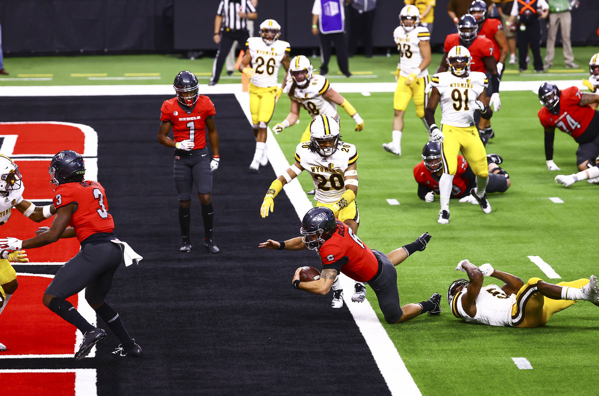 UNLV Rebels quarterback Max Gilliam (6) scores a touchdown against the Wyoming Cowboys during t ...