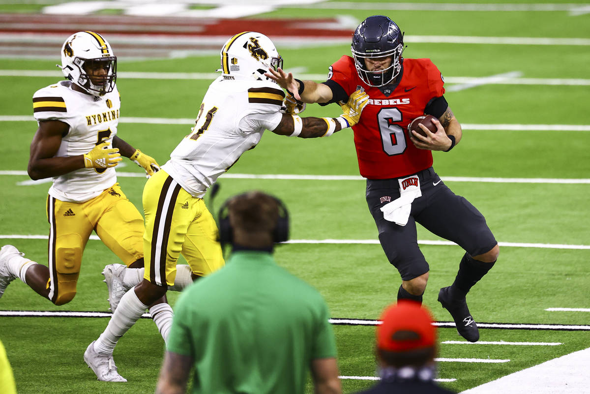 UNLV Rebels quarterback Max Gilliam (6) gets forced out of bounds by Wyoming Cowboys cornerback ...