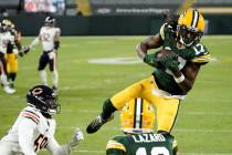 Green Bay Packers' Davante Adams catches a touchdown pass during the first half of an NFL footb ...