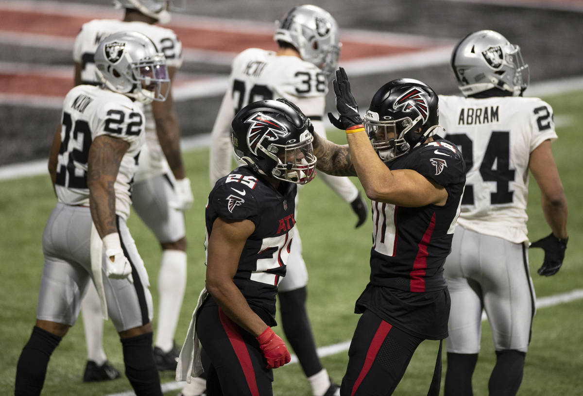 Atlanta Falcons running back Ito Smith (25) and Atlanta Falcons fullback Keith Smith (40) celeb ...