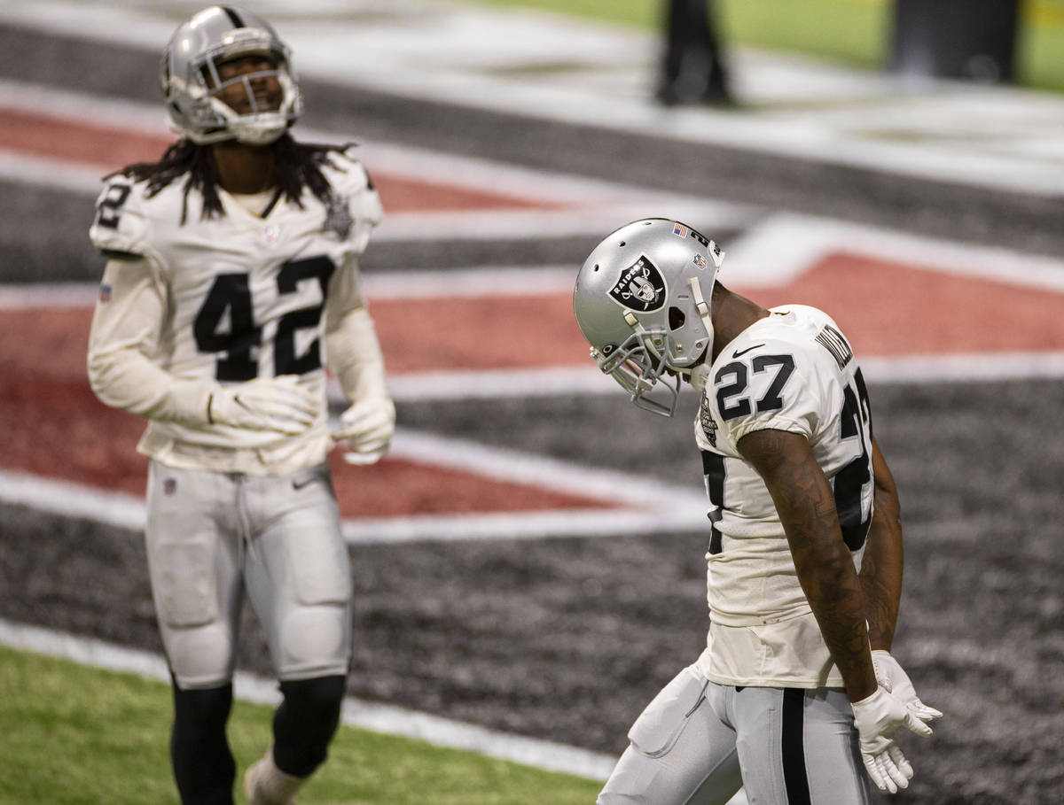 Las Vegas Raiders cornerback Trayvon Mullen (27) and Las Vegas Raiders outside linebacker Cory ...
