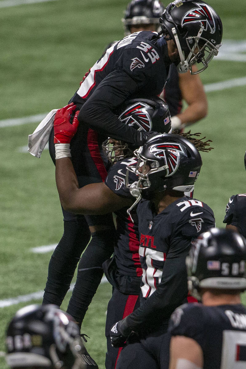 Atlanta Falcons cornerback Blidi Wreh-Wilson (33) celebrates with defensive end Steven Means (5 ...