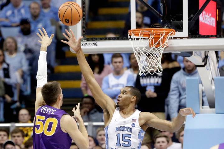 North Carolina's Garrison Brooks (15) defends while Northern Iowa's Austin Phyfe (50) shoots du ...