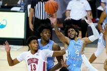 North Carolina guard R.J. Davis (4) leaps to shoot a basket over UNLV guard Bryce Hamilton (13) ...