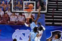 North Carolina guard Leaky Black (1) tries to block a shot by UNLV forward Cheikh Mbacke Diong ...