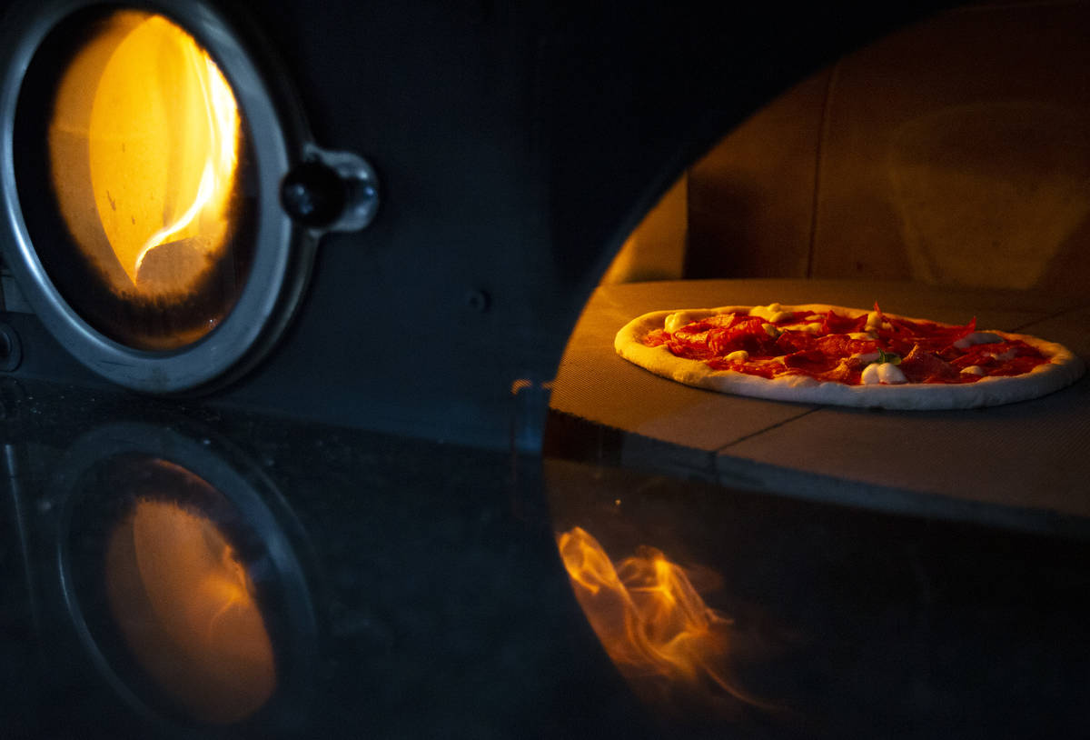 Pizza bakes in a wood-fired rotary oven on the Signora Pizza truck. (Ellen Schmidt/Las Vegas Re ...