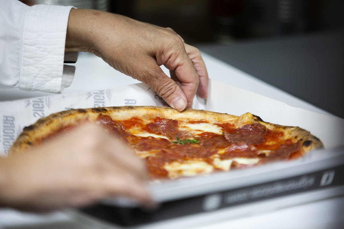 The chef prepares a Diavola Pizza on the Signora Pizza truck. (Ellen Schmidt/Las Vegas Review-J ...