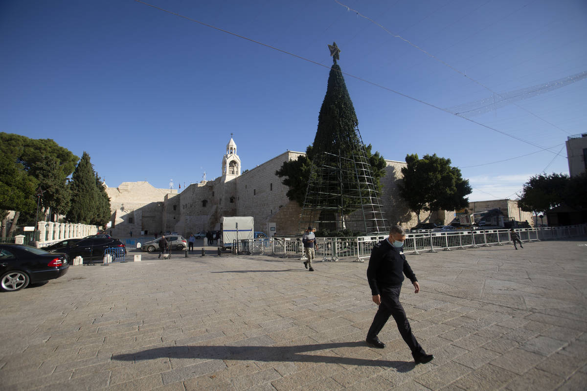 A man walks outside the Church of the Nativity, traditionally believed to be the birthplace of ...